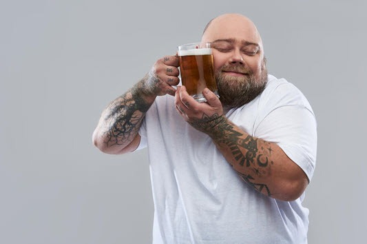 Man hugging a mug of beer